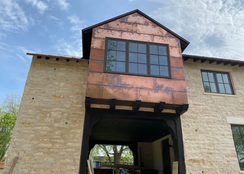 Copper metal panel facade on a stone building for Skylight Installation in Kaysville